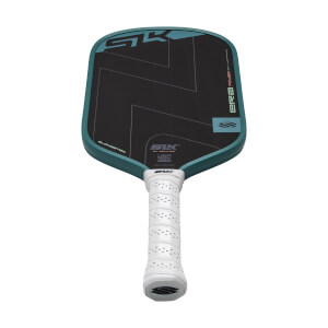 Angled front view of a black pickleball paddle with teal geometric graphics, a teal edge guard, and a white perforated grip.