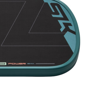 Close-up of the bottom right corner of a black pickleball paddle with a teal edge guard, SLK logo, and POWER 16MM text.