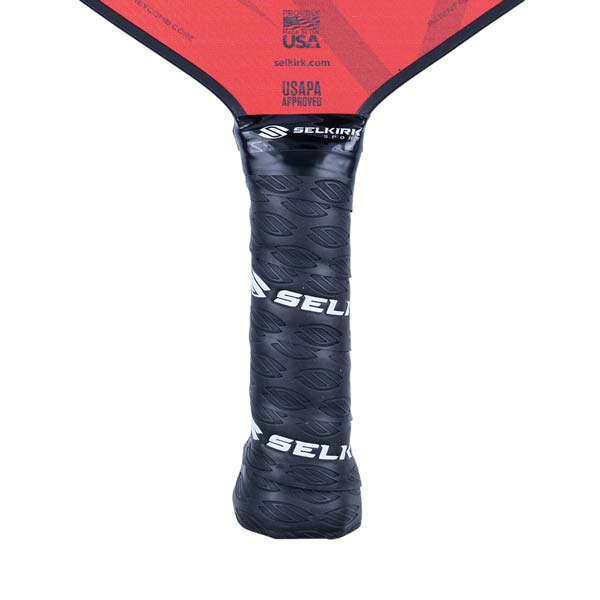 Close-up of a black pickleball paddle grip with Selkirk branding and USAPA approved logo.