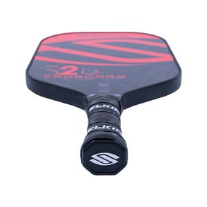 Top-down view of a black pickleball paddle with red S2 VANGUARD graphics and a black grip with white SELKIRK branding.