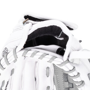 Close-up of a white baseball glove showing the "MADE IN MEXICO" stamp and grey lacing.