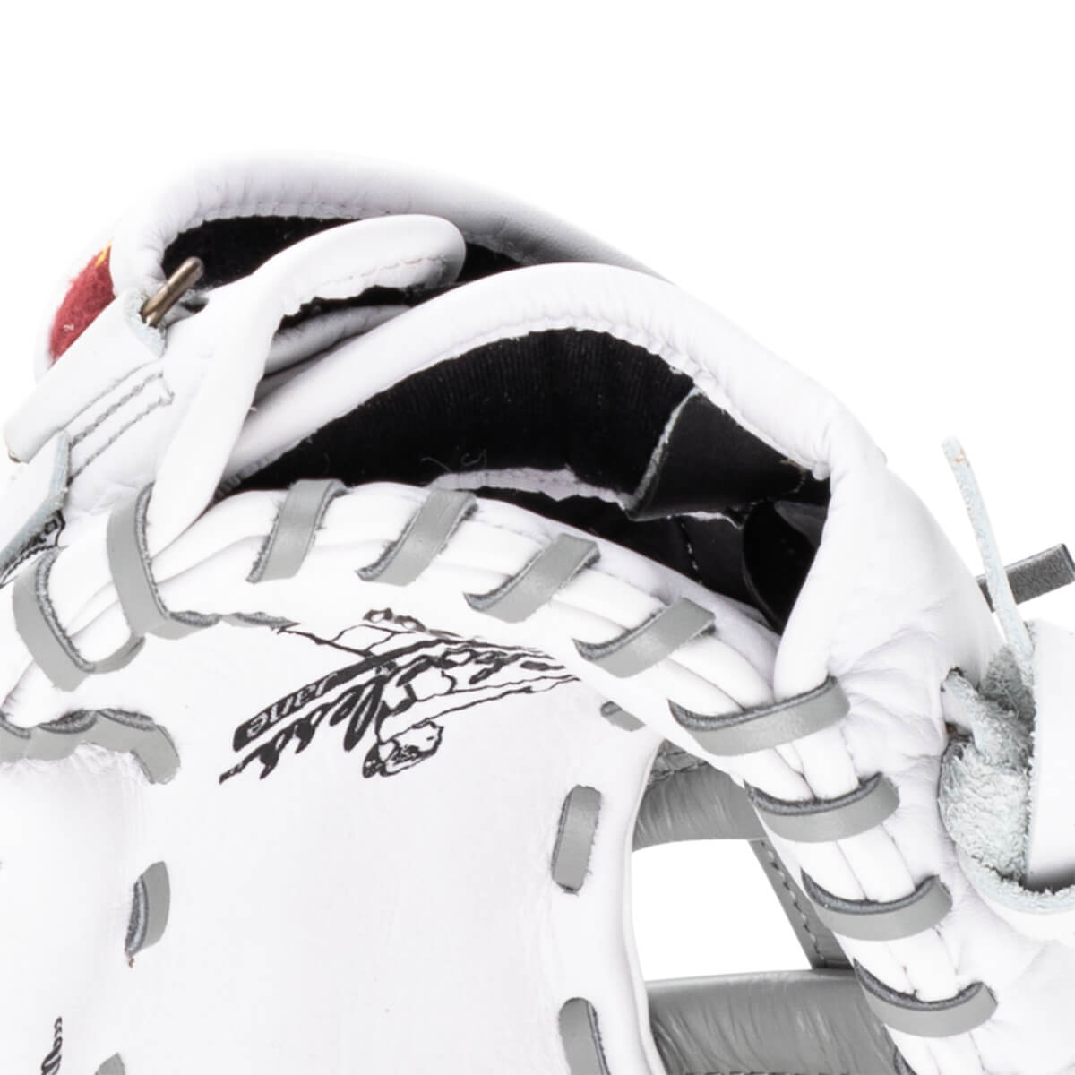 Close-up of a white baseball glove's interior, showing black lining and grey lacing.