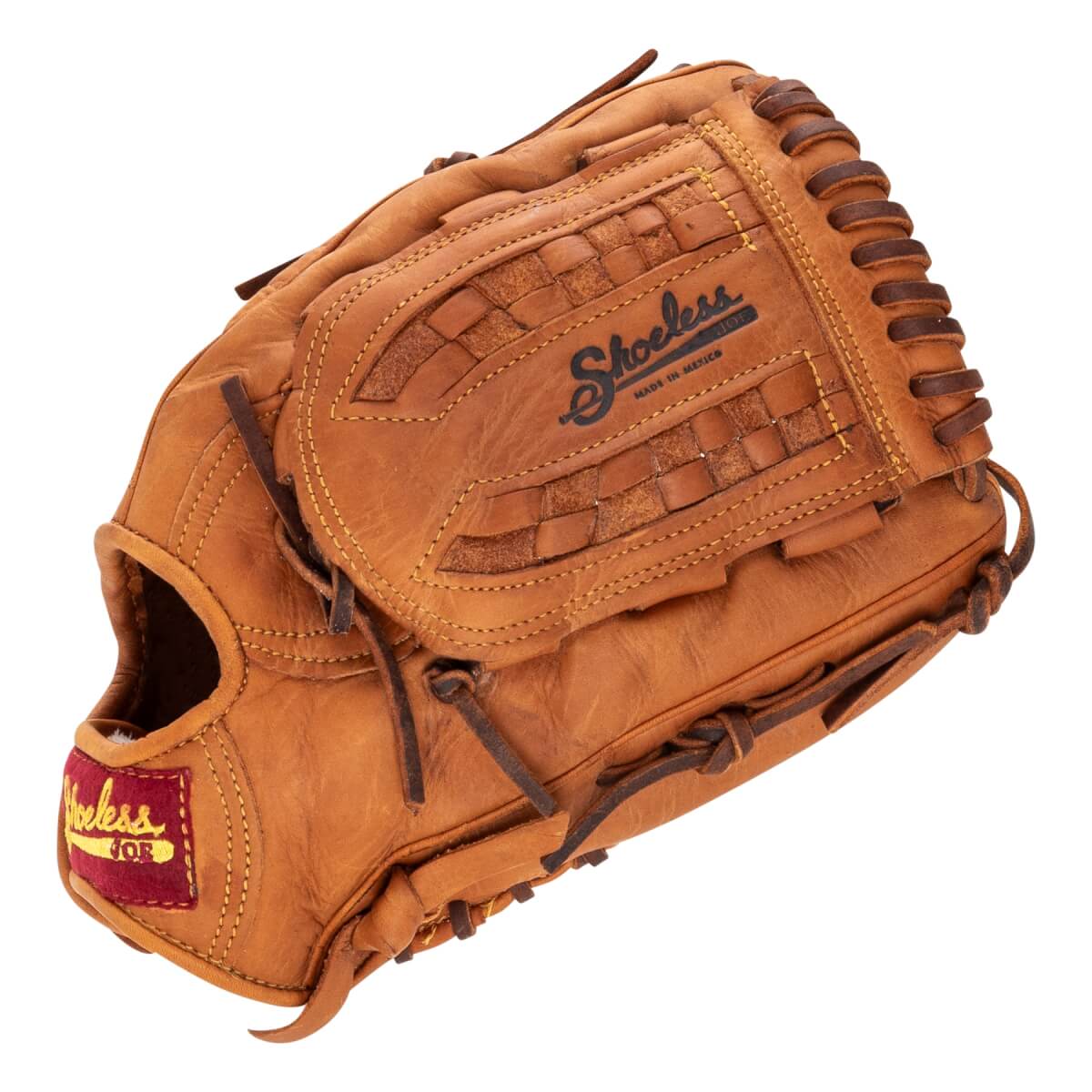 Angled view of a brown baseball glove with a visible Shoeless Joe logo, woven leather details, and a red wrist tag.