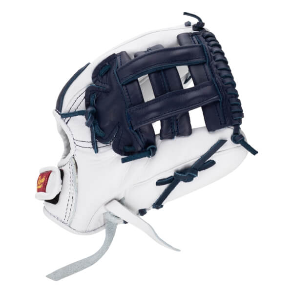 Back view of a white and navy leather softball glove featuring an H-web design and a red Shoeless Joe logo label on the wrist strap.