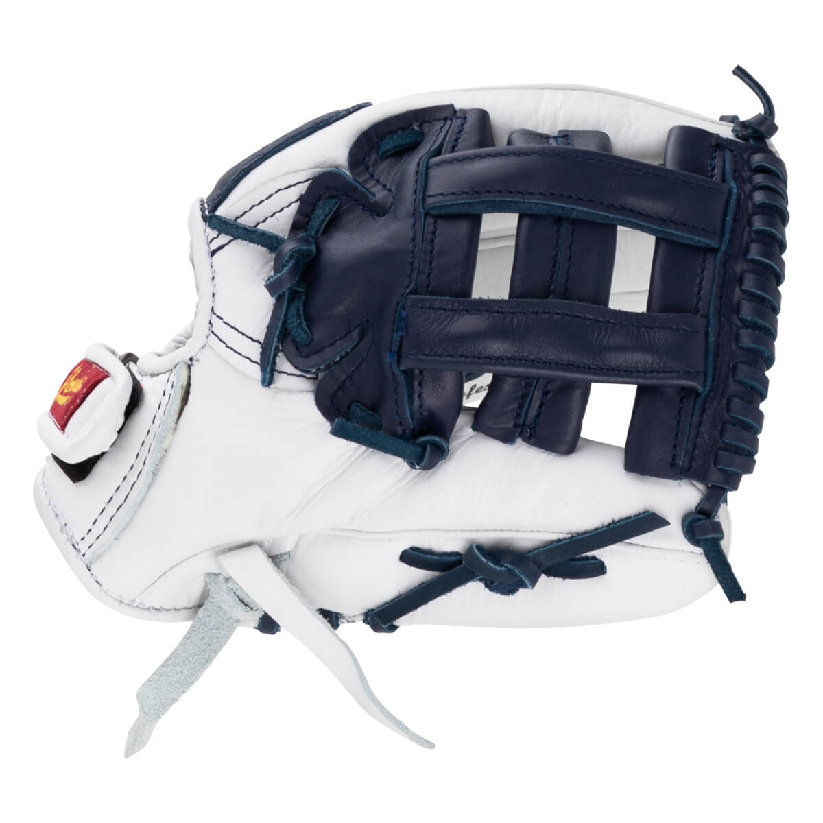 Side view of the white and navy blue leather softball glove featuring a dark blue web and a red brand logo patch on the thumb.