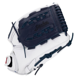 Corner view of a white fastpitch softball glove with navy blue lacing and a woven palm pad showing "Shoeless" script.