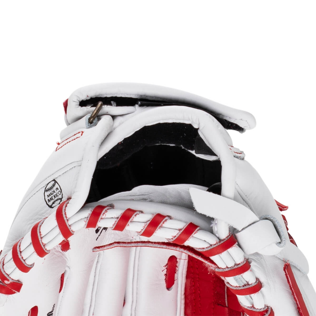 Close-up view of a white and red fastpitch softball glove, showing "MADE IN MEXICO" stamp and red lacing.