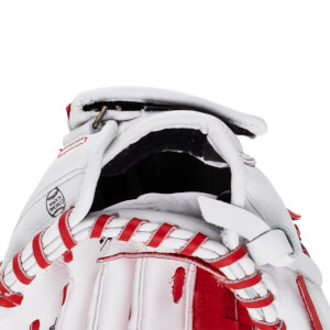 Close-up view of a white and red fastpitch softball glove, showing "MADE IN MEXICO" stamp and red lacing.