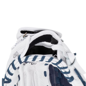 Top-down close-up view of the white softball glove's hand opening featuring navy blue lacing, black interior, and a "MADE IN MEXICO" stamp.