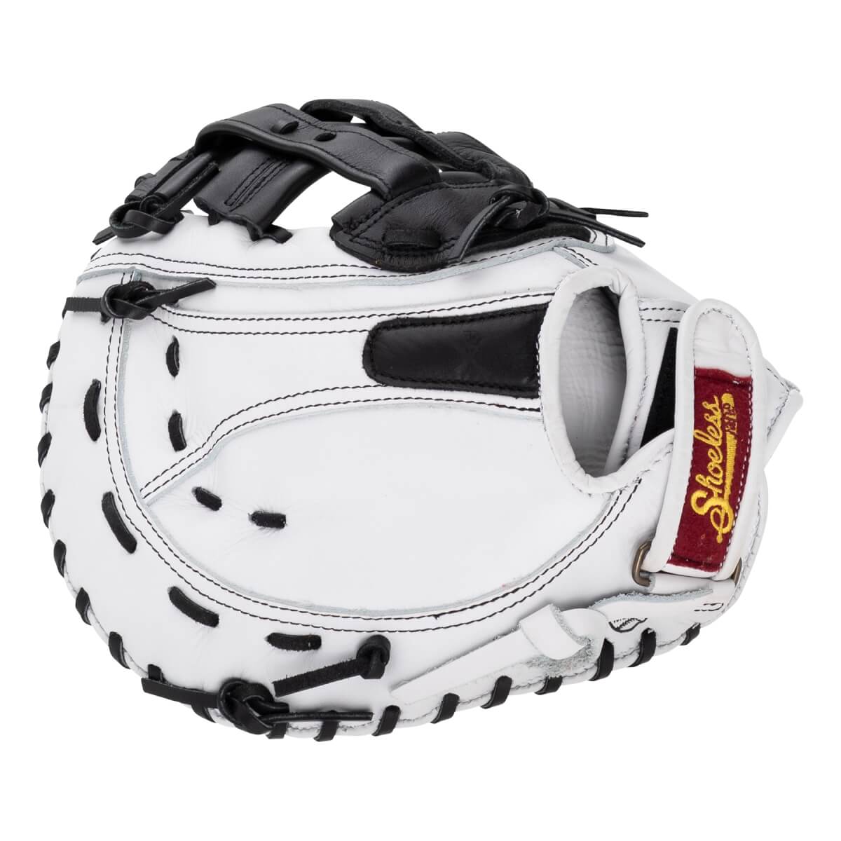 Back view of a white fastpitch first base mitt featuring black webbing, black laces, and a red Shoeless brand patch on the adjustable wrist strap.