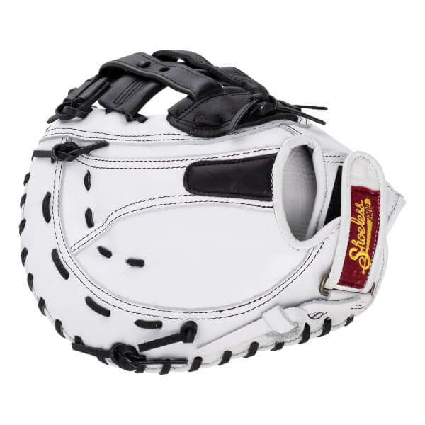 Back view of a white fastpitch first base mitt featuring black webbing, black laces, and a red Shoeless brand patch on the adjustable wrist strap.