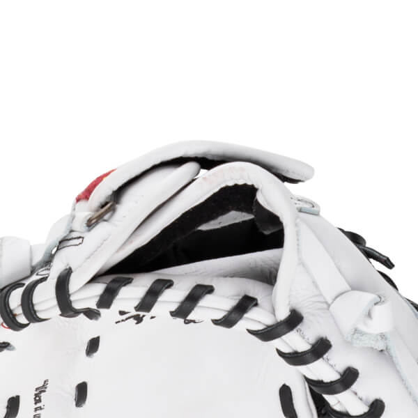 Close-up of the wrist opening on this white leather first base mitt featuring black interior padding, black laces, and an adjustable strap.