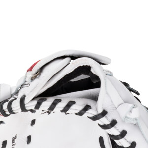 Close-up of the wrist opening on this white leather first base mitt featuring black interior padding, black laces, and an adjustable strap.