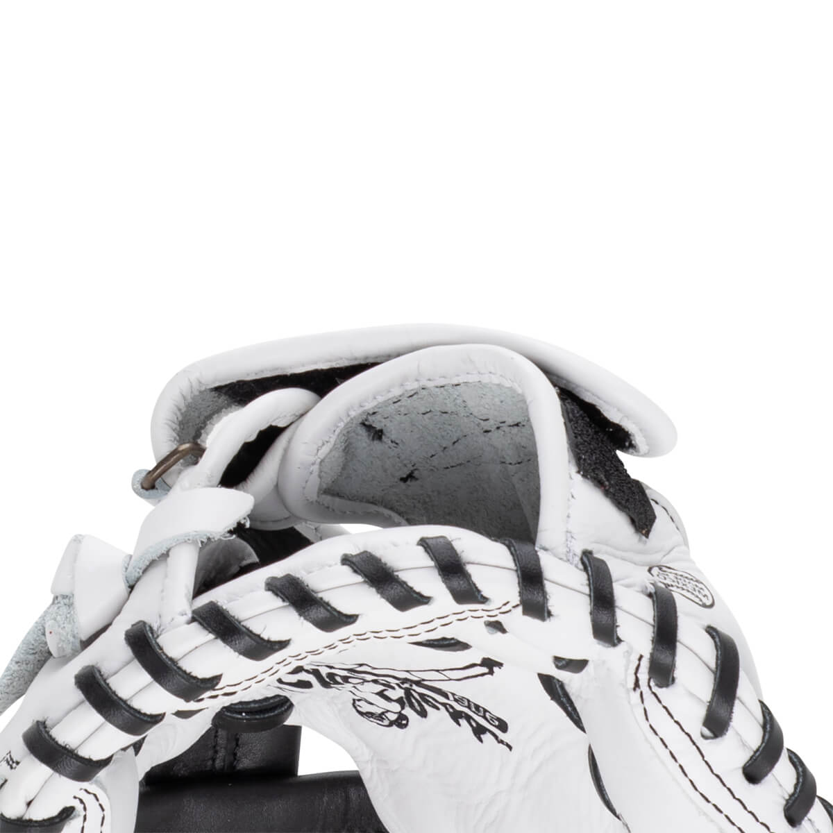 Close-up of the white leather mitt's wrist opening and interior padding with black laces and a partial Shoeless Jane logo graphic.