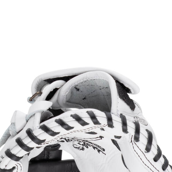 Close-up of the white leather mitt's wrist opening and interior padding with black laces and a partial Shoeless Jane logo graphic.