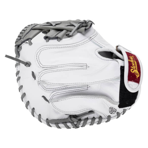 Back view of a white leather baseball catcher's mitt featuring grey laces and a maroon wrist strap with gold script "Shoeless" text.