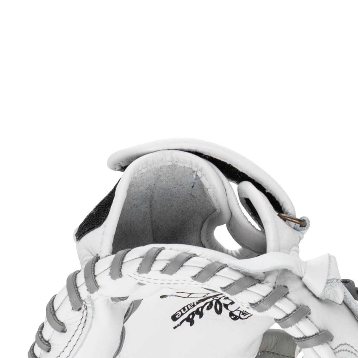 Close-up view of the white leather Shoeless Jane glove wrist strap featuring grey lacing and a black hook-and-loop closure.