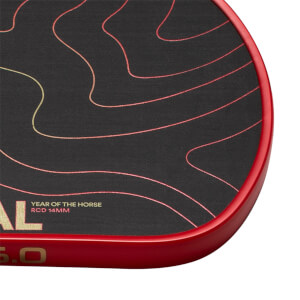 Close-up of a black pickleball paddle corner with wavy red lines, a red edge guard, and YEAR OF THE HORSE RCD 14MM text.