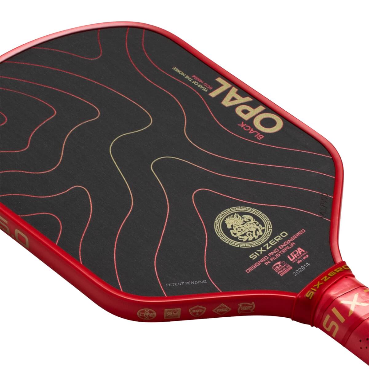 Angled close-up of a black Six Zero pickleball paddle with red edge, gold OPAL text, and a horse emblem.
