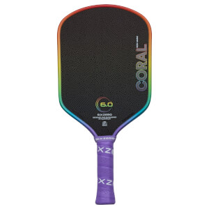 Back view of a pickleball paddle with a black textured surface, rainbow-colored edge, and "CORAL" text.