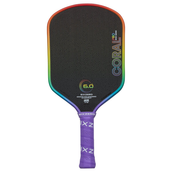 Front view of a black pickleball paddle with a rainbow edge, showing "CORAL PRO" and "6.0" graphics.