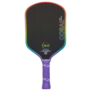 Front view of a black pickleball paddle with a rainbow edge, showing "CORAL PRO" and "6.0" graphics.