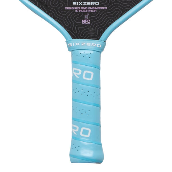 Close-up of a light blue wrapped pickleball paddle handle and black face featuring "SIXZERO" branding and a light pink topographic pattern.