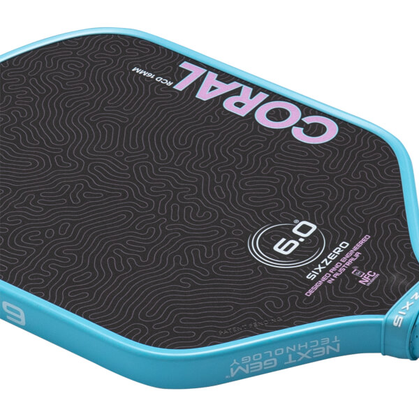 Angled close-up of the Coral 6.0 pickleball paddle showing pink topographic patterns on a black face and a light blue rim with Next Gen Technology text.