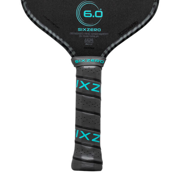 Close-up of a pickleball paddle grip showing the "SIXZERO" logo and teal "IXZ" lettering.