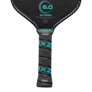 Close-up of a pickleball paddle grip showing the "SIXZERO" logo and teal "IXZ" lettering.