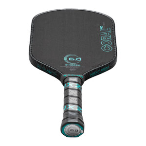 Top-down view of a black pickleball paddle with "CORAL PRO" and "SIXZERO" text, and a "6.0" logo.