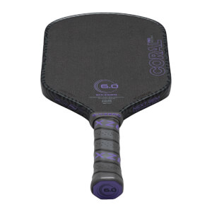 Top-down view of a black pickleball paddle with purple "CORAL PRO" text and a "6.0" logo.
