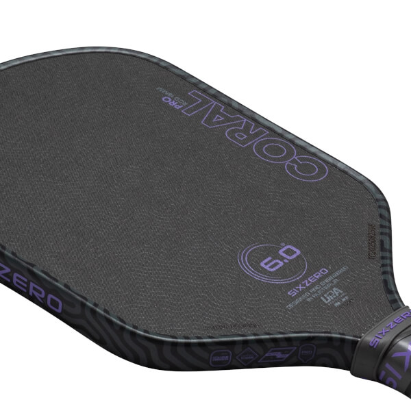 Top-down view of a pickleball paddle showing the "CORAL" logo, "6.0" rating, and "SIXZERO" branding.