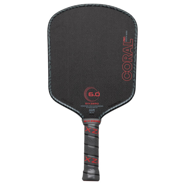Front view of a black pickleball paddle with red "CORAL PRO" text and a textured surface.