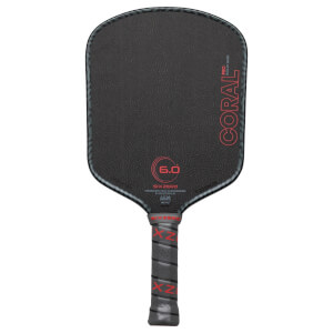 Front view of a black pickleball paddle with red "CORAL PRO" text and a textured surface.