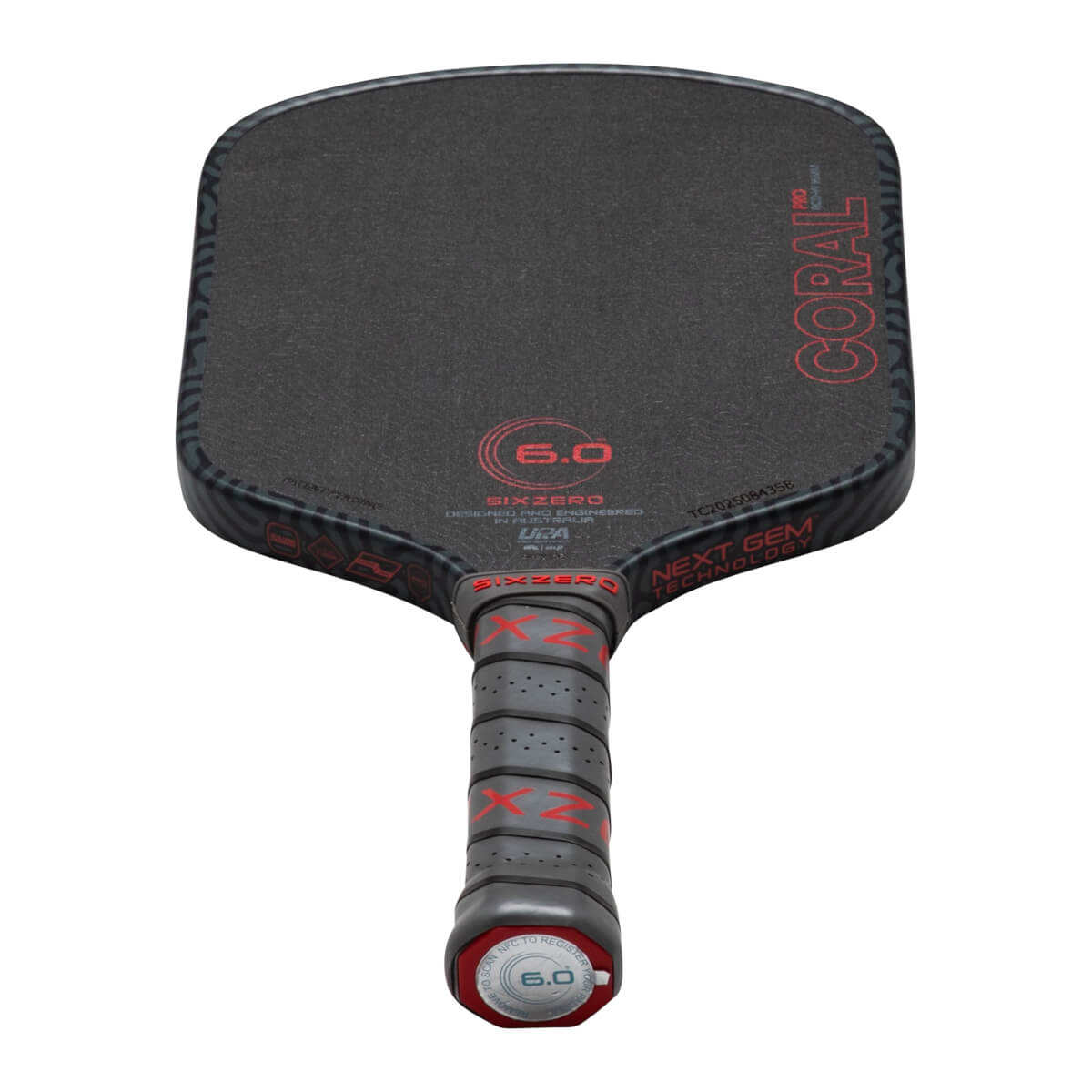 Top-down view of a black pickleball paddle with red "CORAL PRO" text and a textured grip.