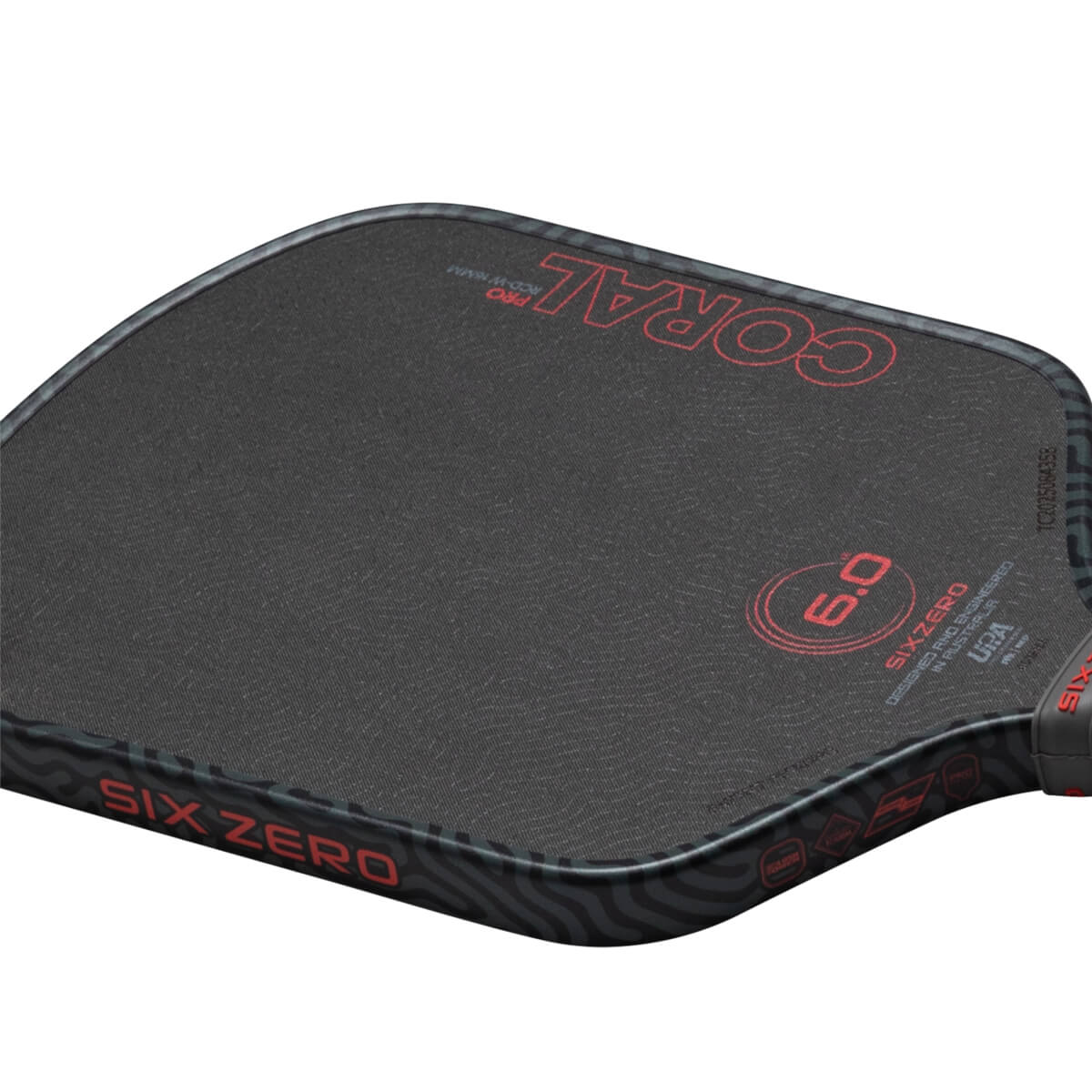 Close-up of a pickleball paddle showing the "SIX ZERO" logo, "CORAL PRO" text, and a "6.0" rating.