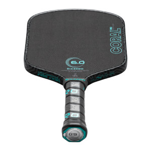 Front view of a black pickleball paddle with "CORAL PRO" and "SIXZERO" logos in teal.