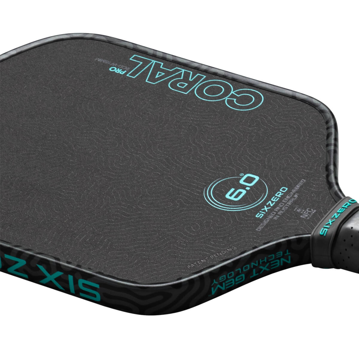 Top-down view of a pickleball paddle showing the "CORAL PRO" text and a "6.0" graphic.