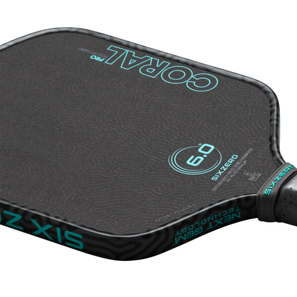 Top-down view of a pickleball paddle showing the "CORAL PRO" text and a "6.0" graphic.