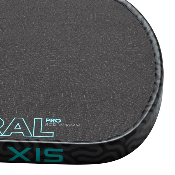 Corner view of a dark grey paddle with a textured surface, showing "ORAL PRO RCD-W 16MM" and "XIS" in teal lettering.
