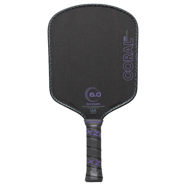 Front view of a black pickleball paddle with purple "CORAL PRO" text and a "6.0" graphic.