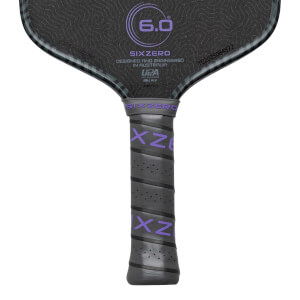 Top-down view of a pickleball paddle showing the "SIXZERO" logo, "6.0" in a circle, and a textured grip with purple "XZ" lettering.