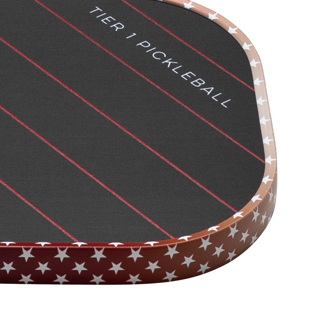 Corner view of a pickleball paddle with "TIER 1 PICKLEBALL" text, red stripes, and a star pattern on the edge.