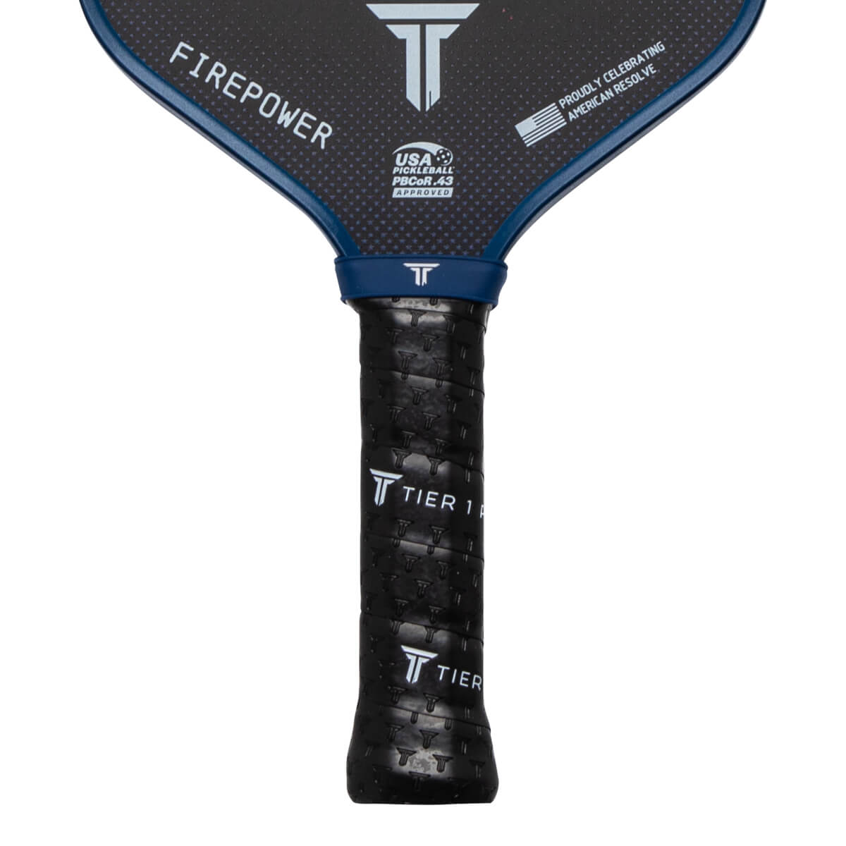 Close-up of a pickleball paddle grip showing "TIER 1" text and a textured pattern.
