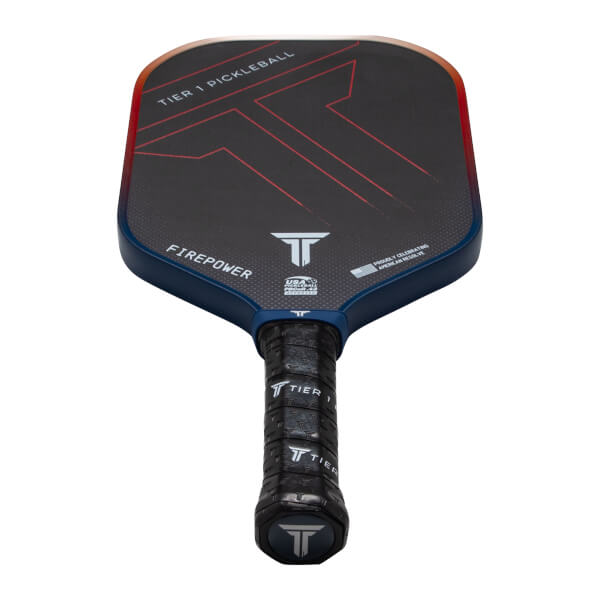Top-down view of a black pickleball paddle with red accents, "TIER 1 PICKLEBALL" text, and a "FIREPOWER" label.