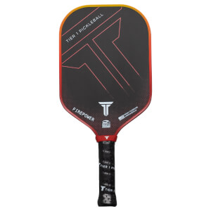 Front view of a black pickleball paddle with red and yellow accents, featuring "TIER 1 PICKLEBALL" and "FIREPOWER" text.