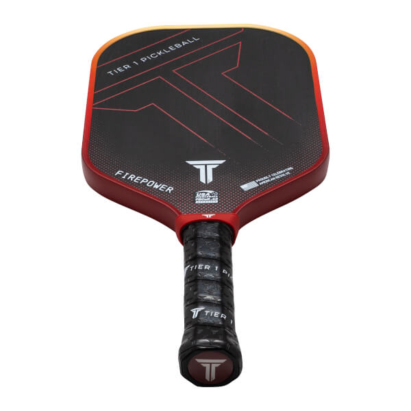 Top-down view of a red and black pickleball paddle with "TIER 1 PICKLEBALL" and "FIREPOWER" text.