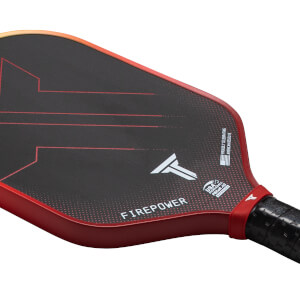 Close-up of a pickleball paddle showing the "FIREPOWER" text, a white "T" logo, and a USA Pickleball approved stamp.