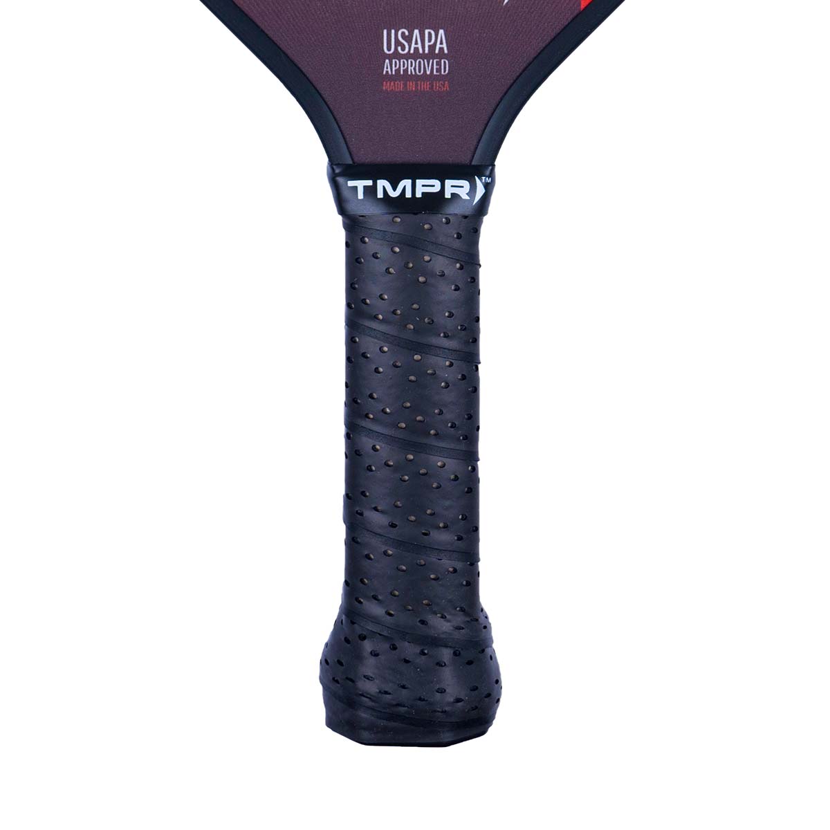 Close-up of a black pickleball paddle grip with perforations and the TMPR logo.